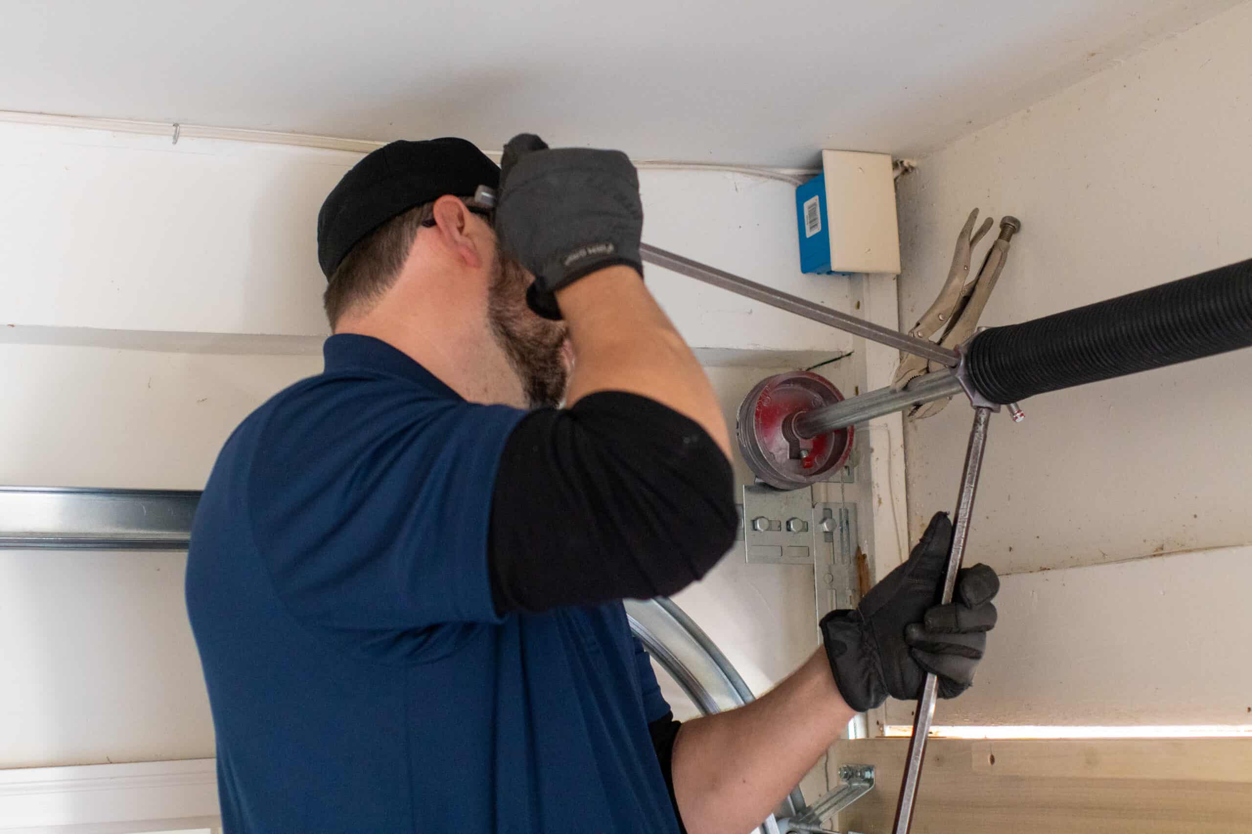Garage door repair tech winding springs in Buford GA